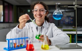 A photo showing a student in a science lab performing an experiment